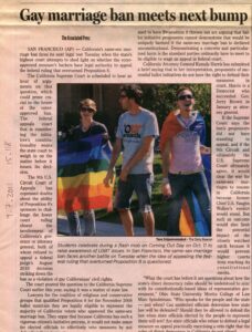 Image of article from Daily Beacon with title Gay Marriage Ban Meets Next Bump. Three people in photo with rainbow flags.
